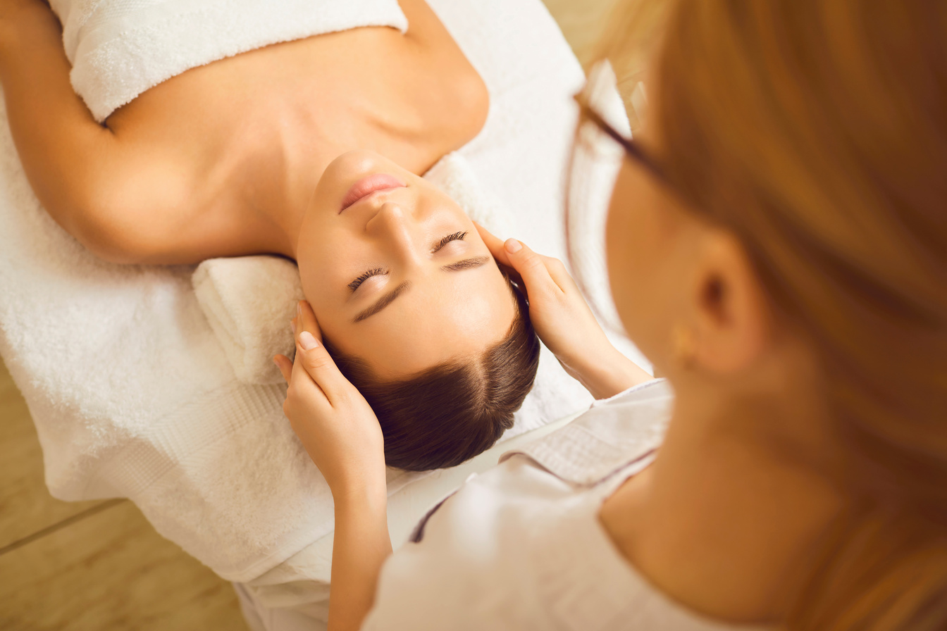 Face Massage to Young Woman Close up.